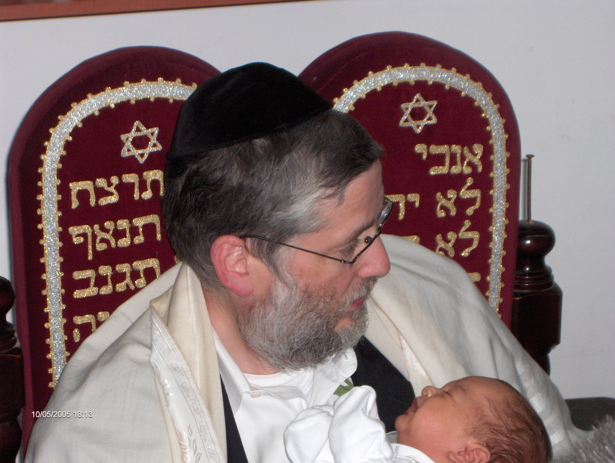 Rabbi Avraham Wolfson, sandek at a Bris Milah